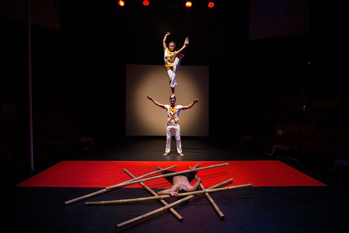SIEM REAP, CAMBODIA - JULY 01:  Cambodian circus artists perform in front of a crowd of foreign tourists on July 1, 2015 during a performance of "Eclipse" at Phare - The Cambodian Circus in Siem Reap, Cambodia. Phare Ponleu Salpak is an organization providing free education and artistic training to Cambodian children. Students in the organization's circus program often go on to careers performing both internationally and domestically at venues like Phare - The Cambodian Circus in Siem Reap.  (Photo by Taylor Weidman/Getty Images)