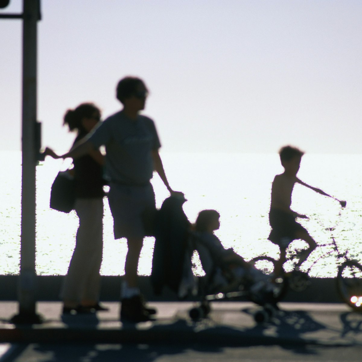 A family takes an early evening stroll along Redondo Beach in Los Angeles.