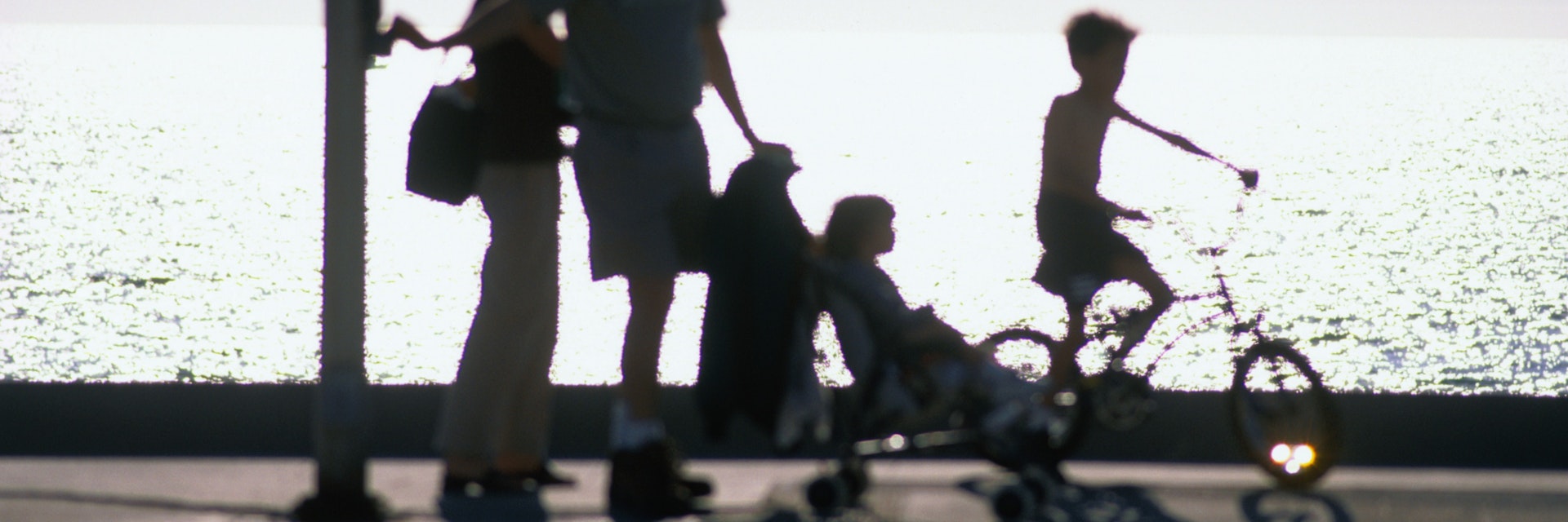 A family takes an early evening stroll along Redondo Beach in Los Angeles.