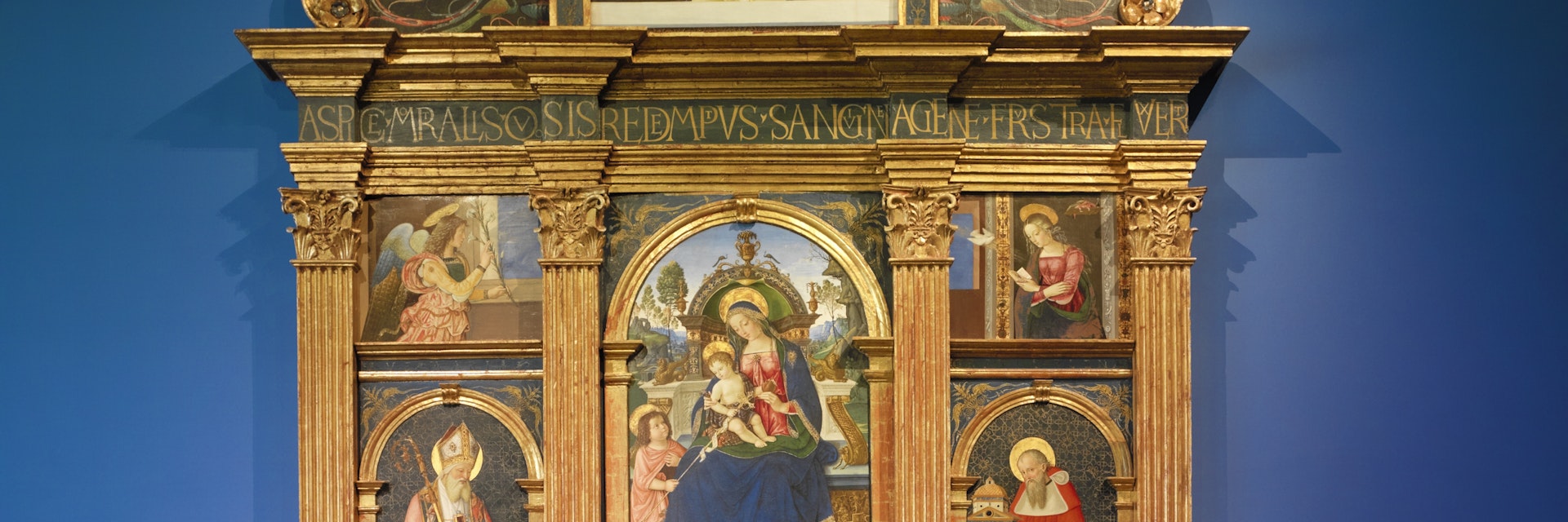 Tourist admire Pintoricchio's Pala di Santa Maria dei Fossi(1495)  in the National Gallery of Umbria.(Galleria Nazionale dell'Umbria). In the center of the multipaneled painting, the Madonna holds baby Jesus on her lap and a Pomergrante in the other hand.