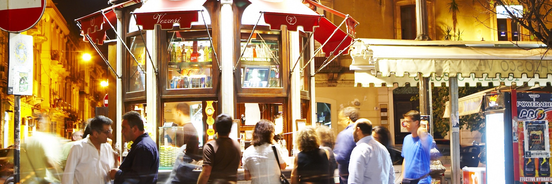 People at roadside granita stall.