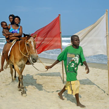 Ghana, Greater Accra, Accra. Labadi beach is Accra's premiere beach - horse rides are one of the attractions.