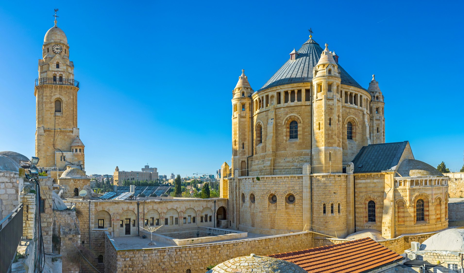 The house roofs are the best viewpoint, overlooking the huge building of the Dormition Abbey, with its clock tower and tiny belfries, Jerusalem, Israel.