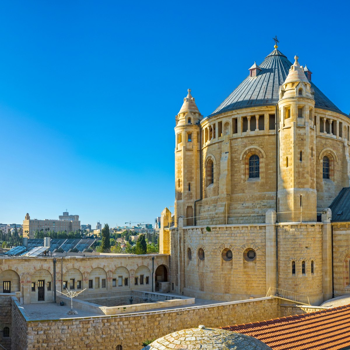 The house roofs are the best viewpoint, overlooking the huge building of the Dormition Abbey, with its clock tower and tiny belfries, Jerusalem, Israel.