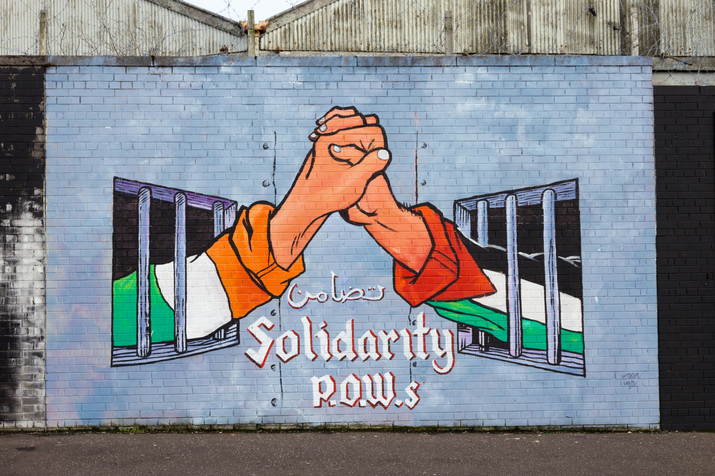 BELFAST, NORTHERN IRELAND - FEB 9, 2014: Political mural in Belfast, Northern Ireland. Falls Road is famous for its political murals. ; Shutterstock ID 191463122; Your name (First / Last): Lauren Gillmore; GL account no.: 56530; Netsuite department name: Online-Design; Full Product or Project name including edition: 65050/ Online Design /LaurenGillmore/IFY