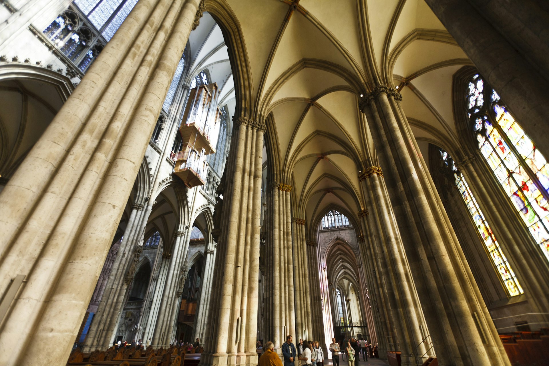Lofty arches, columns and stained glass windows of the Gothic Cologne Cathedral (Kolner Dom)
