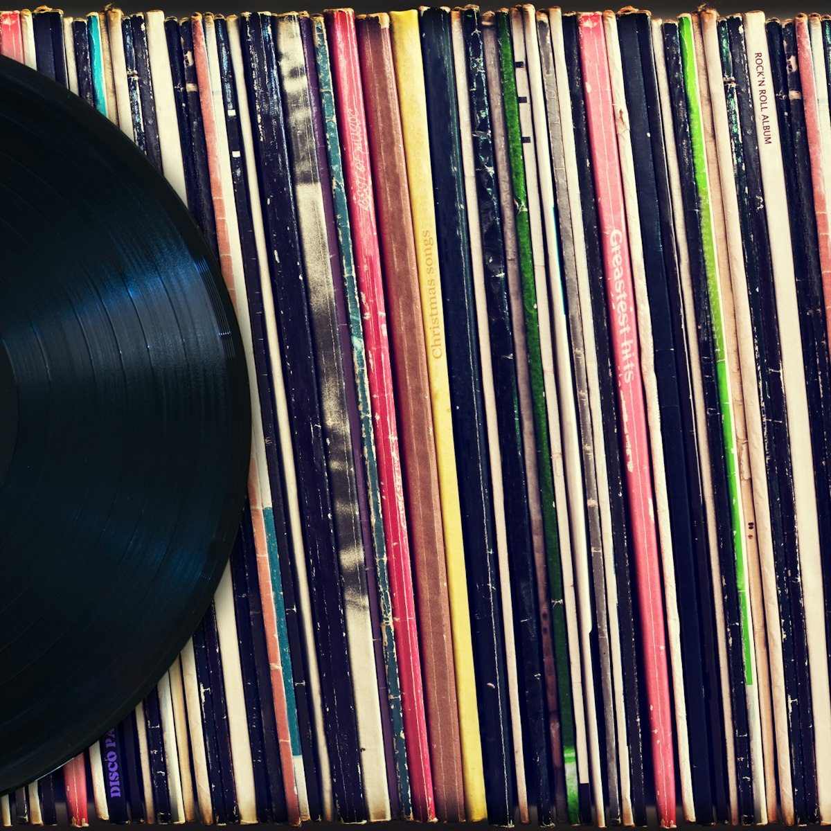 500px Photo ID: 115969675 - Vinyl record with copy space in front of a collection of albums (dummy titles), vintage process