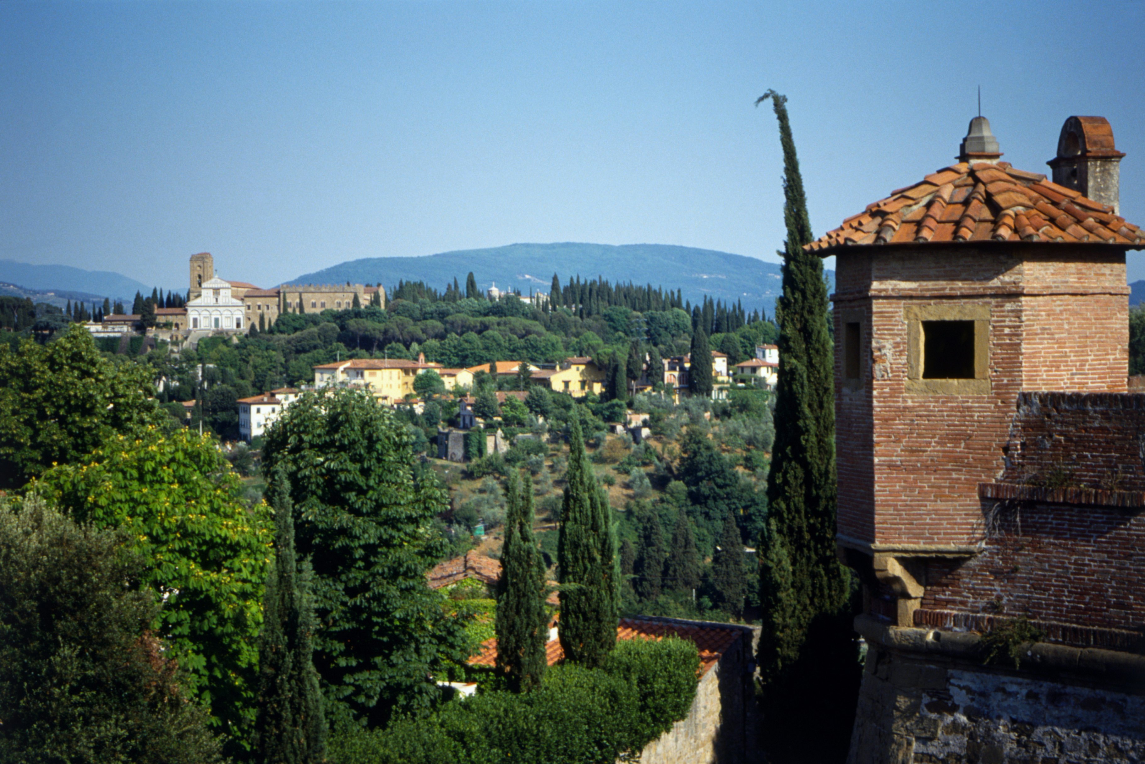 Italy, Florence, view across to San Miniato al Monte from Forte di Belvedere, with many cypress trees.