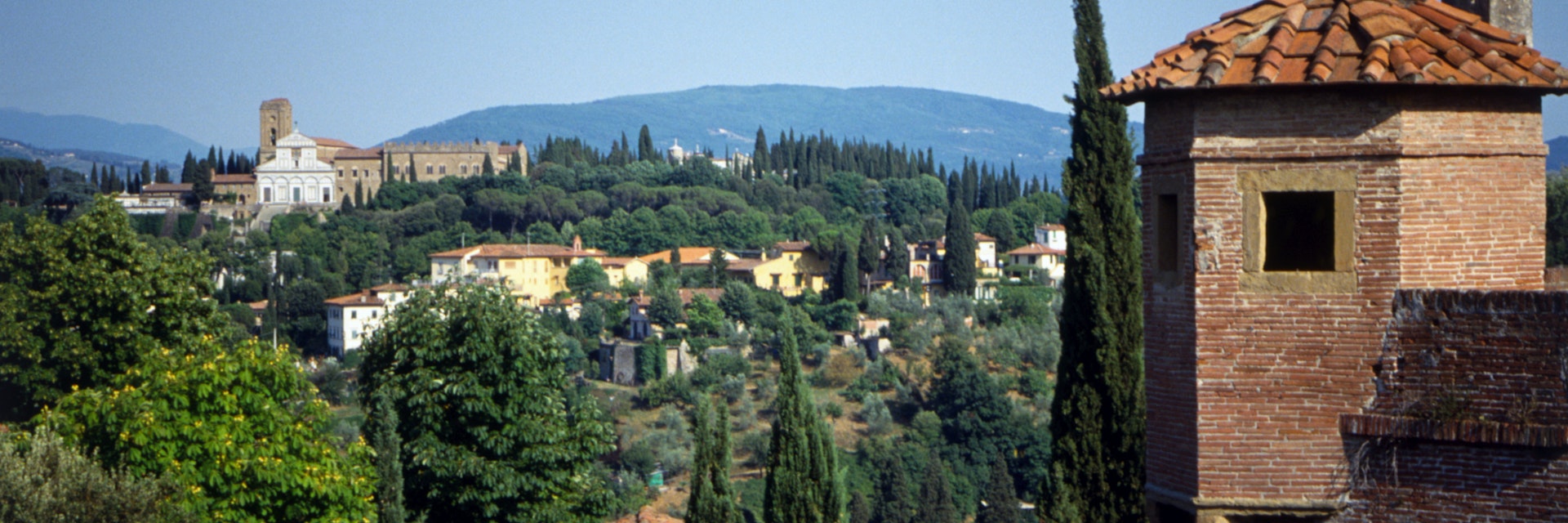 Italy, Florence, view across to San Miniato al Monte from Forte di Belvedere, with many cypress trees.