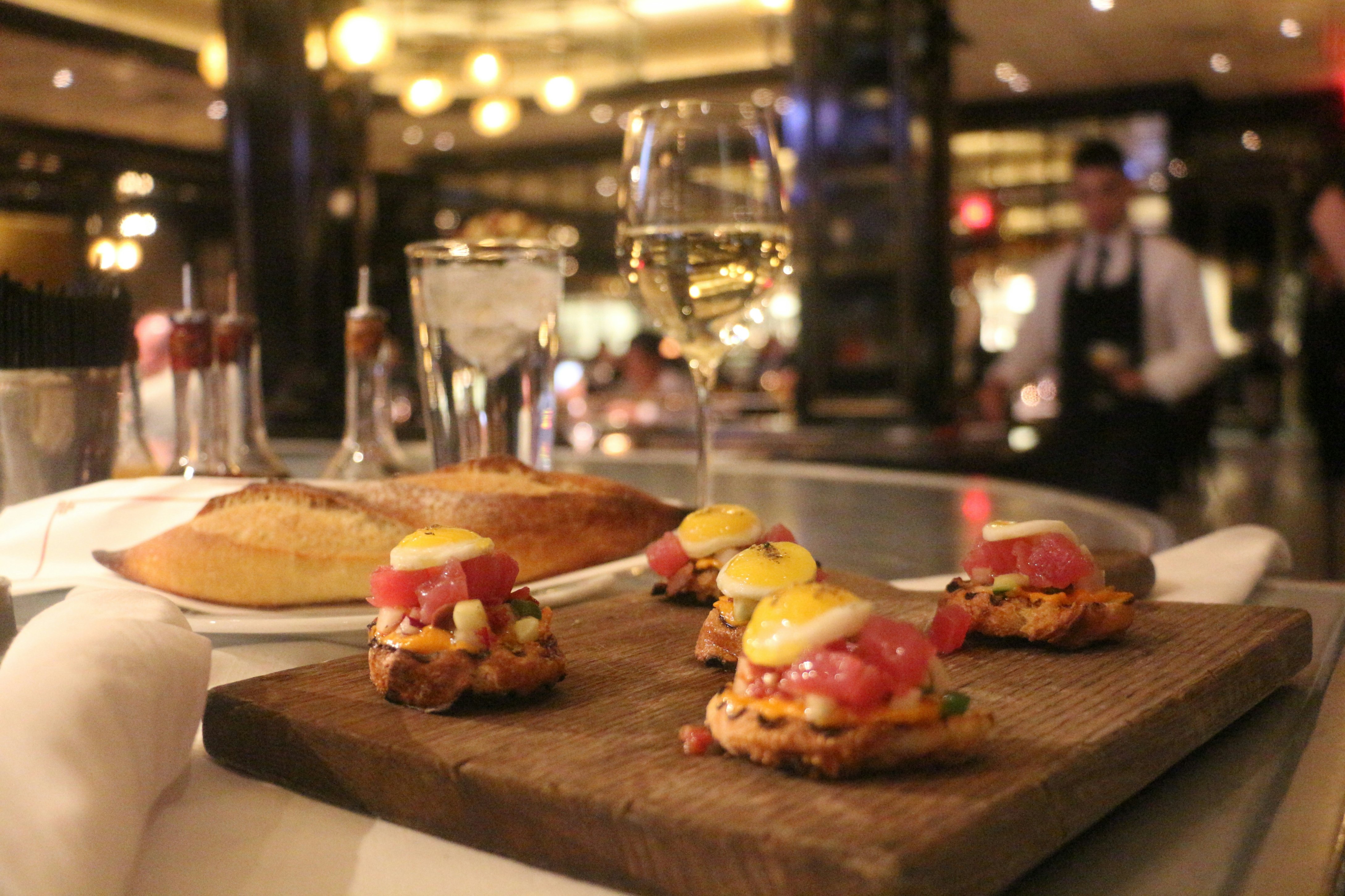 Tuna tartare and a glass of white wine at Bardot Bistro in the Aria.