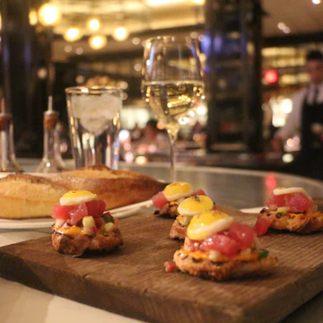 Tuna tartare and a glass of white wine at Bardot Bistro in the Aria.