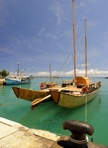 Traditional double-hulled canoe Marumaru Atua docked at Avarua harbour.