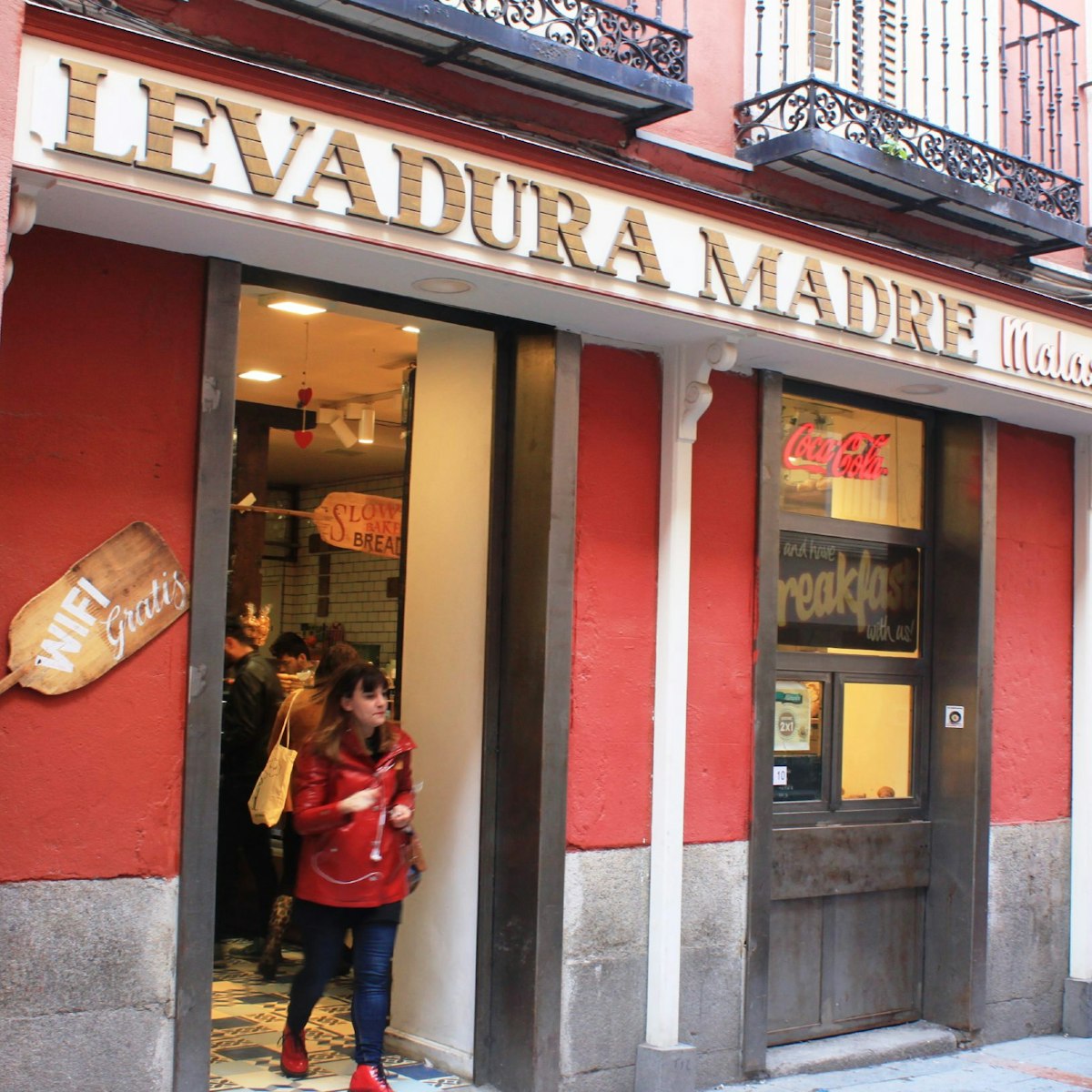 The bright red entrance to Levadura Madre Malasaña.