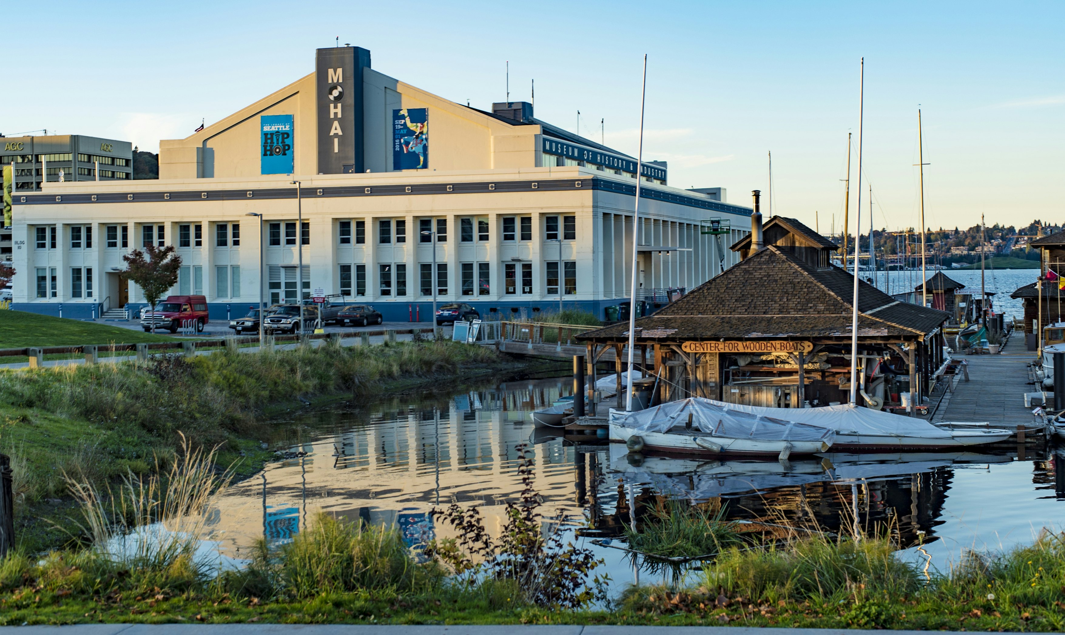 SEATTLE, WASHINGTON/USA - OCT 20, 2015: MOHAI Museum and Center for Wooden Boats glow under an orange sunset on South Lake Union During the Legacy of Seattle HipHop Exhibit; Shutterstock ID 329774729; Your name (First / Last): Alexander Howard; GL account no.: 65050; Netsuite department name: Online Editorial; Full Product or Project name including edition: Western USA neighborhood POI highlights