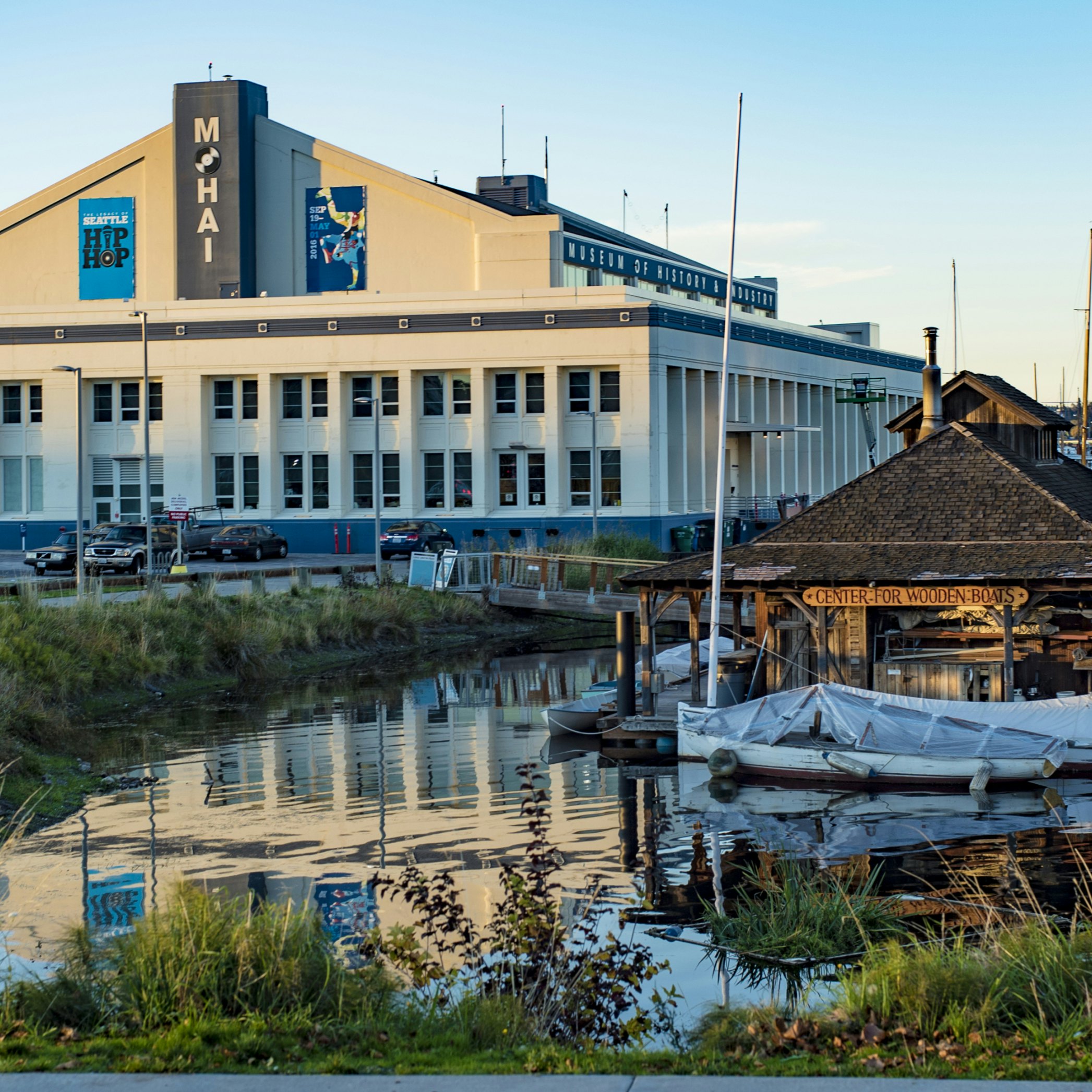 SEATTLE, WASHINGTON/USA - OCT 20, 2015: MOHAI Museum and Center for Wooden Boats glow under an orange sunset on South Lake Union During the Legacy of Seattle HipHop Exhibit; Shutterstock ID 329774729; Your name (First / Last): Alexander Howard; GL account no.: 65050; Netsuite department name: Online Editorial; Full Product or Project name including edition: Western USA neighborhood POI highlights