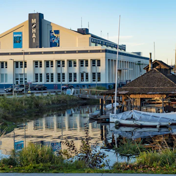 SEATTLE, WASHINGTON/USA - OCT 20, 2015: MOHAI Museum and Center for Wooden Boats glow under an orange sunset on South Lake Union During the Legacy of Seattle HipHop Exhibit; Shutterstock ID 329774729; Your name (First / Last): Alexander Howard; GL account no.: 65050; Netsuite department name: Online Editorial; Full Product or Project name including edition: Western USA neighborhood POI highlights