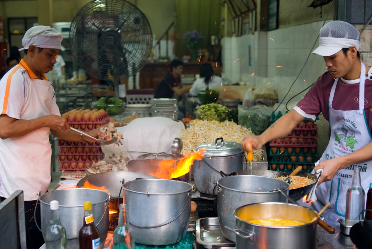 Men preparing food, Thip Samai.