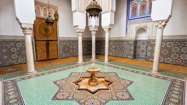 MEKNES, MOROCCO - FEBRUARY 29, 2016: Mausoleum of Moulay Ismail interior in Meknes in Morocco. Mausoleum of Moulay Ismail is a tomb and mosque located in the Morocco city of Meknes.; Shutterstock ID 421915627; Your name (First / Last): Lauren Keith; GL account no.: 65050; Netsuite department name: Online Editorial; Full Product or Project name including edition: Day in Meknes article