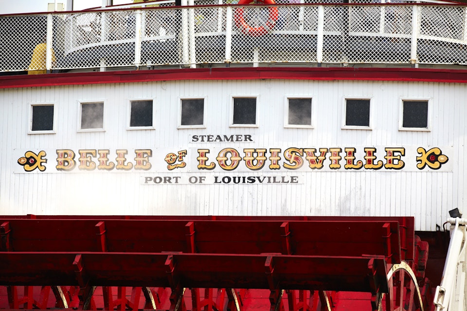 Painted sign above the paddles of the 'Belle of Louisville' on Ohio River.