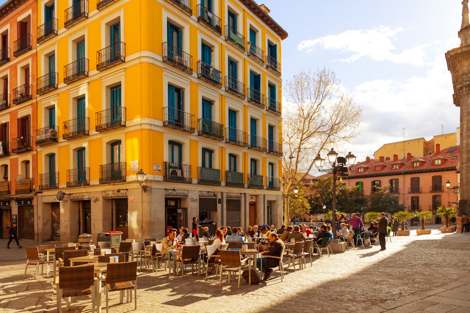 MADRID, SPAIN - APRIL 3: People relaxing in a bar terrace in La Latina district, a very typical area to enjoy the spanish food and drink culture, on April 3, 2014 in Madrid, Spain; Shutterstock ID 187121855