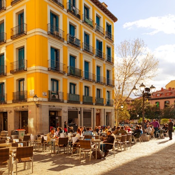 MADRID, SPAIN - APRIL 3: People relaxing in a bar terrace in La Latina district, a very typical area to enjoy the spanish food and drink culture, on April 3, 2014 in Madrid, Spain; Shutterstock ID 187121855