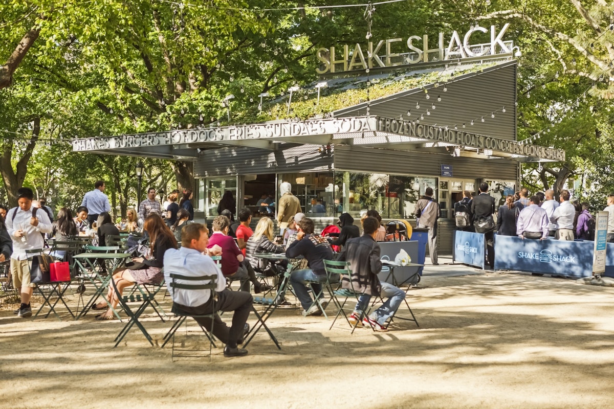 New York, New York, USA - May 12, 2011: Shake Shack in Madison Square Park in New York City is known for quality "fast food". It is also known for the long lines of people waiting to order.; Shutterstock ID 315279176; Your name (First / Last): Lauren Gillmore; GL account no.: 56530; Netsuite department name: Online-Design; Full Product or Project name including edition: 65050/ Online Design /LaurenGillmore/POI