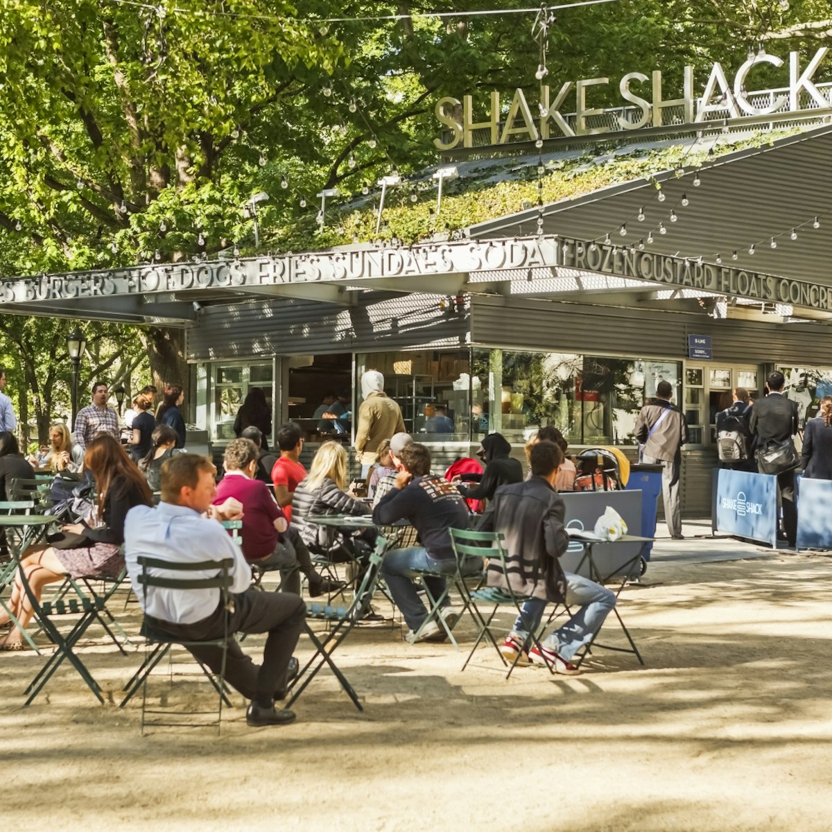 New York, New York, USA - May 12, 2011: Shake Shack in Madison Square Park in New York City is known for quality "fast food". It is also known for the long lines of people waiting to order.; Shutterstock ID 315279176; Your name (First / Last): Lauren Gillmore; GL account no.: 56530; Netsuite department name: Online-Design; Full Product or Project name including edition: 65050/ Online Design /LaurenGillmore/POI