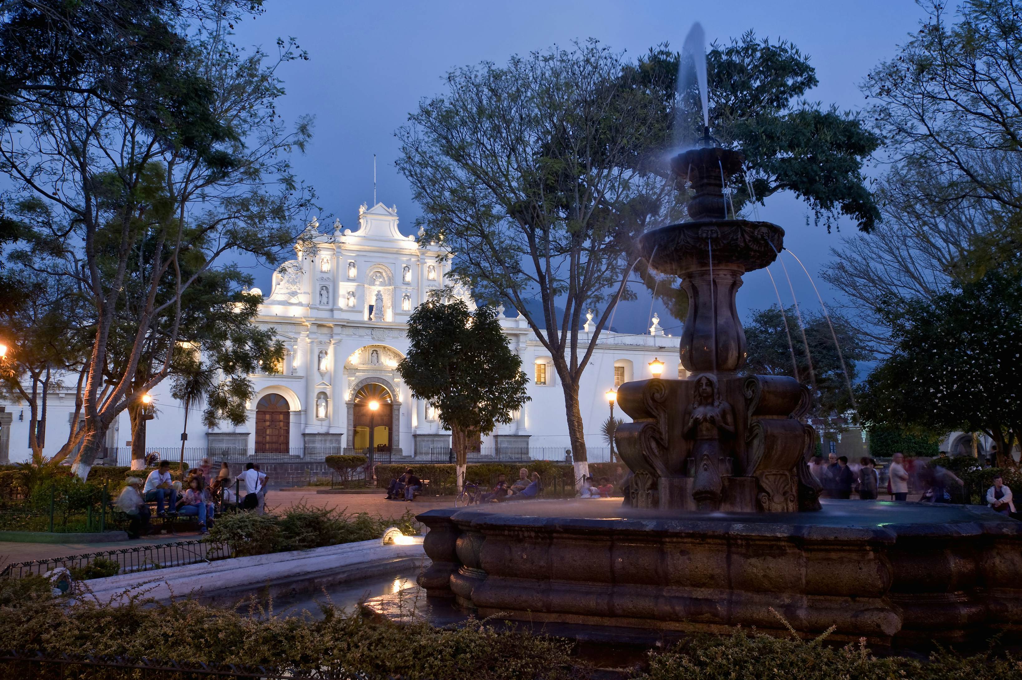 The center fountain in Parque Central in Antigua Guatemala at night. Famous  for its well-preserved Spanish baroque architecture as well as a number of  ruins from earthquakes, Antigua Guatemala is a UNESCO