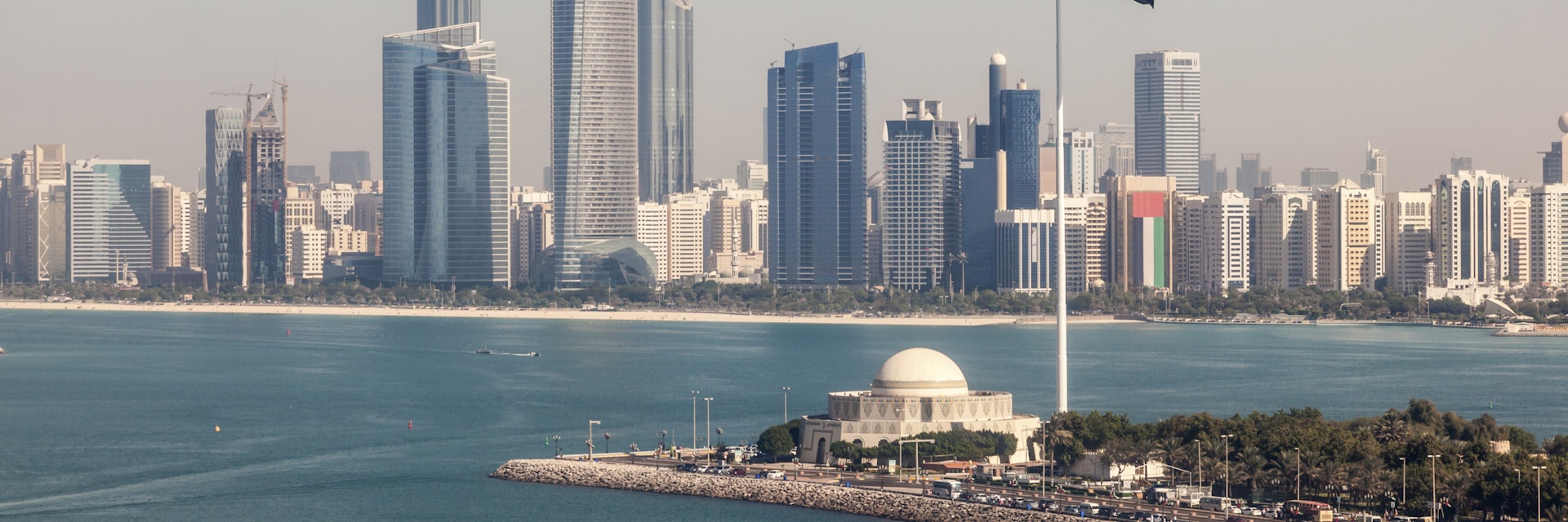 Elevated view of Abu Dhabi downtown skyline and corniche with the flag pole. United Arab Emirates, Middle East