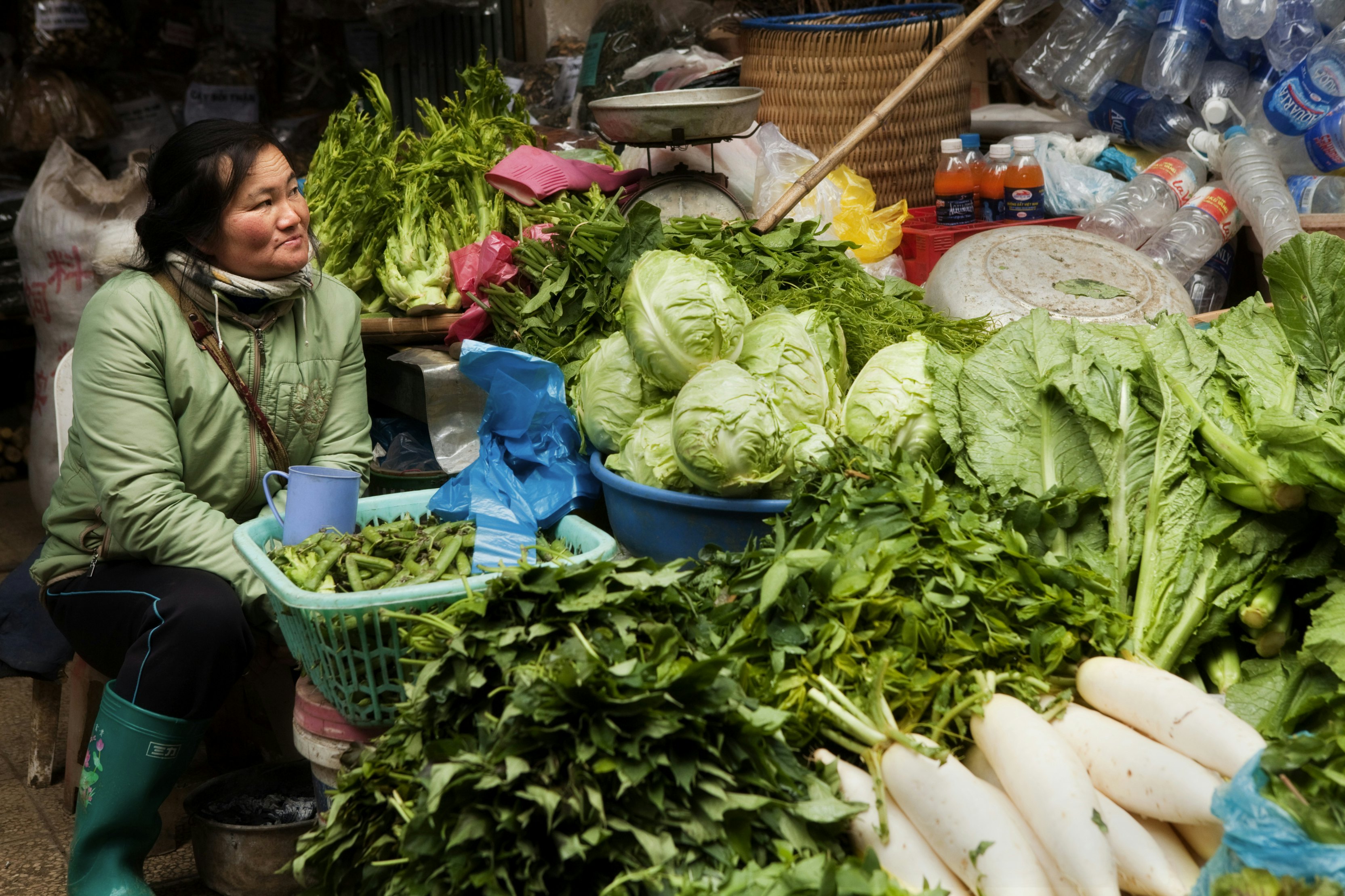 Woman selling green vegetables at Sapa market.
