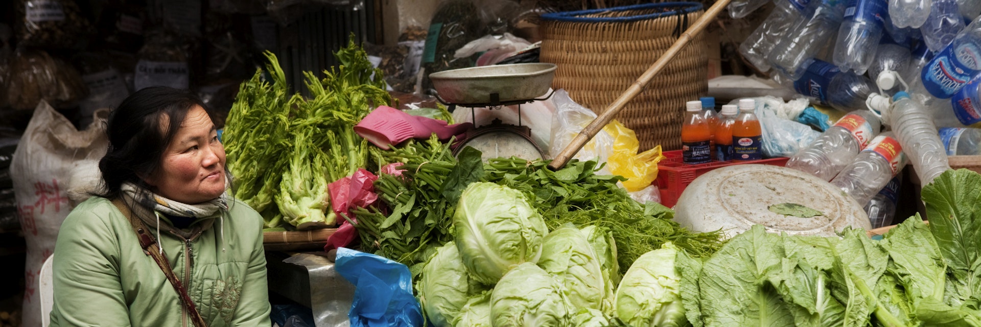 Woman selling green vegetables at Sapa market.