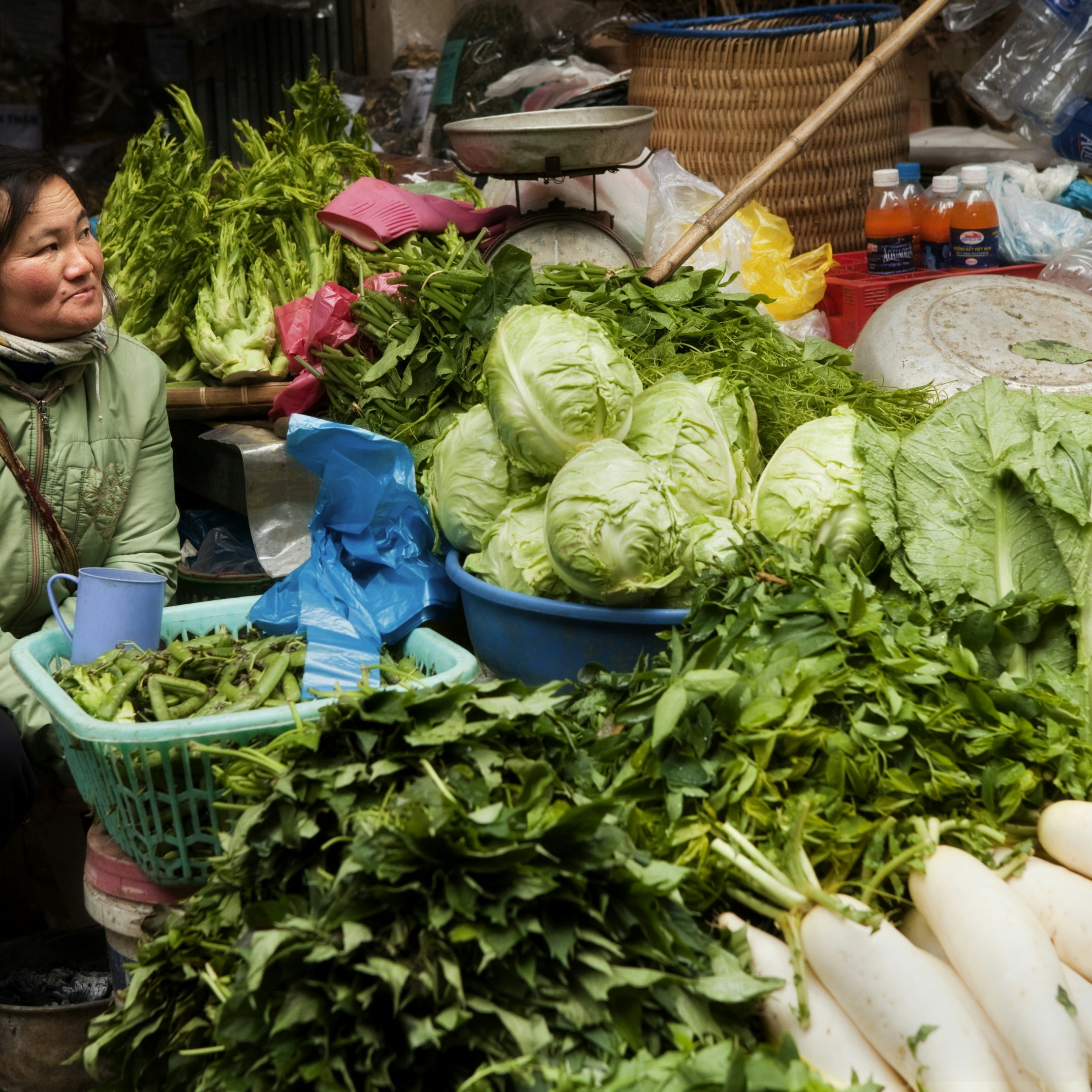 Woman selling green vegetables at Sapa market.