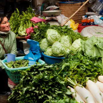 Woman selling green vegetables at Sapa market.
