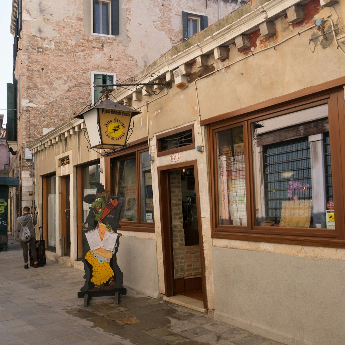 The entrance to the pizzeria on busy Barbaria de le Tole