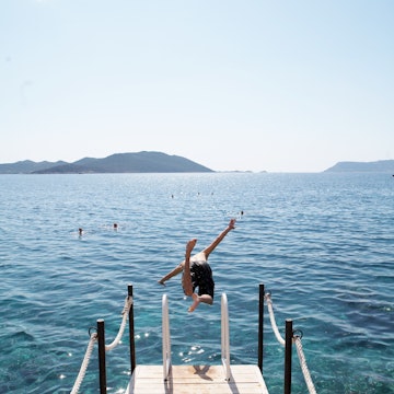 Boy diving off jetty.