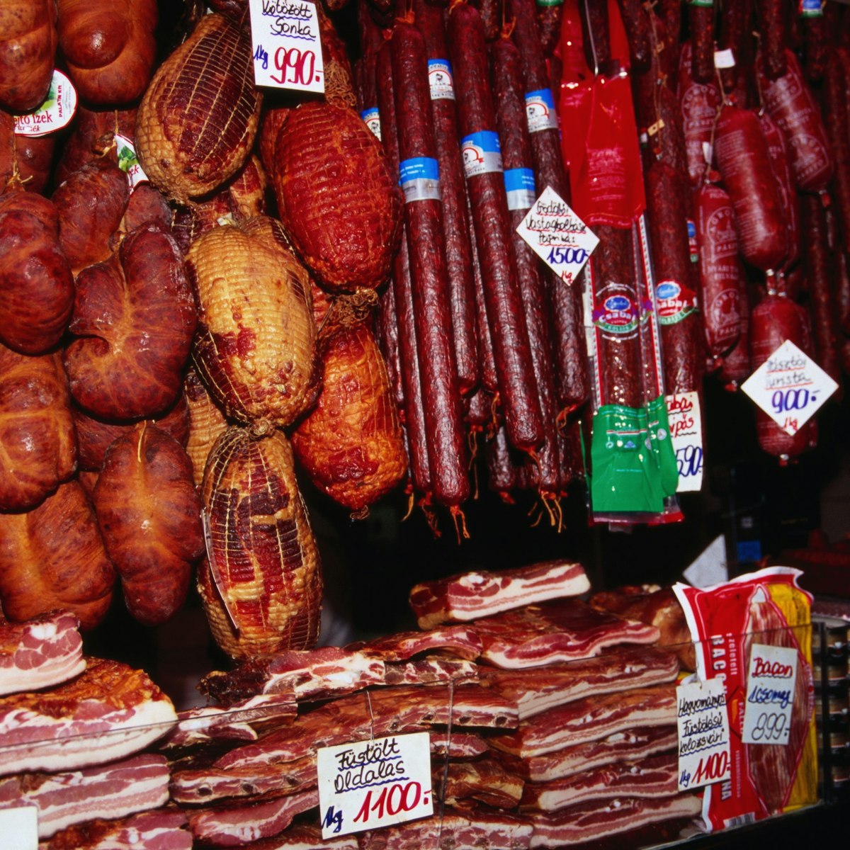 Smoked sausage meat hanging at food stall at Nagycsarnok Market.