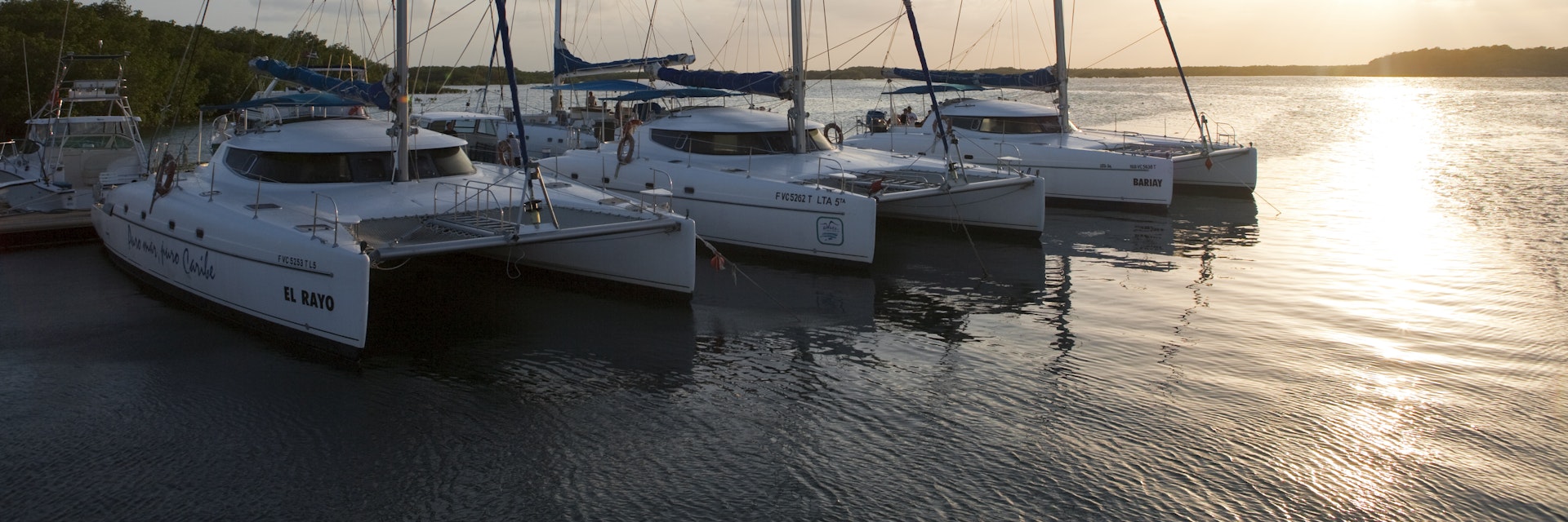 Catamarans at Marina Gaviota at sunset.