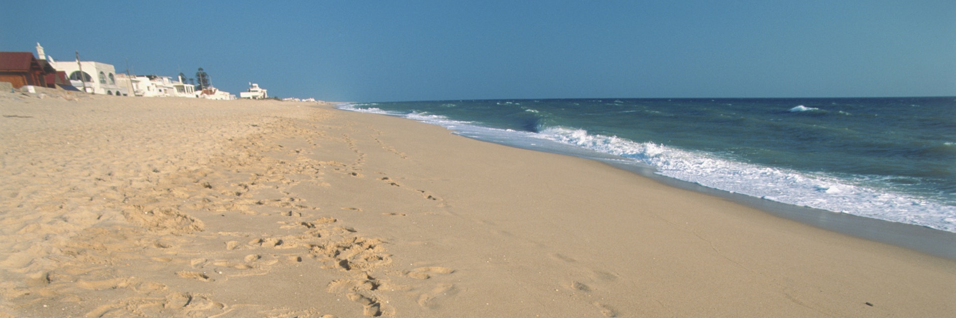 Portugal, Algarve, Ilha de Faro, footprints on sandy beach