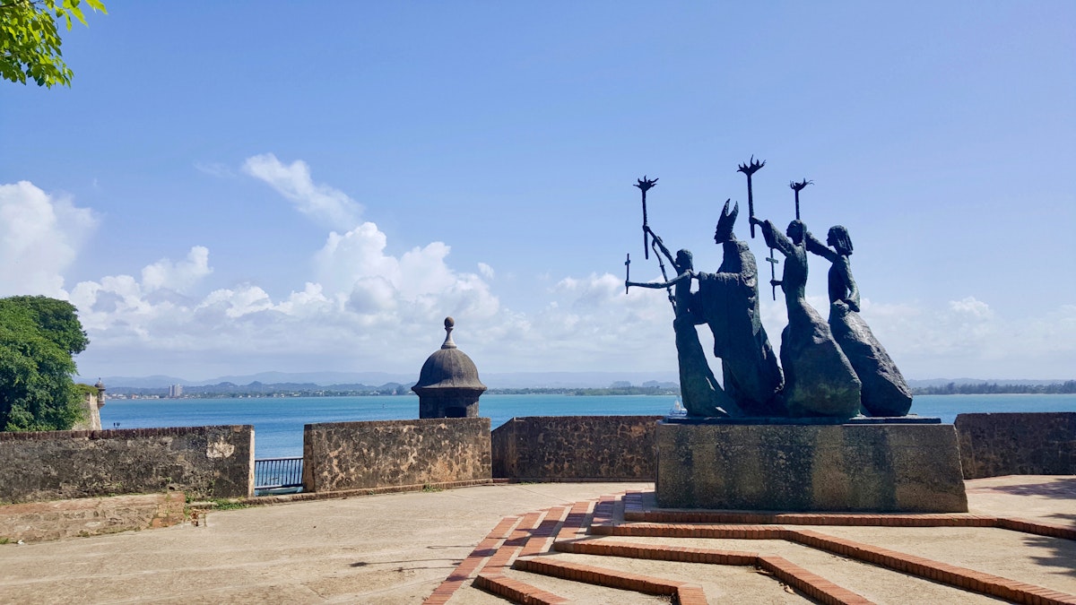 Side view of bronze statue by the water in Old San Juan.