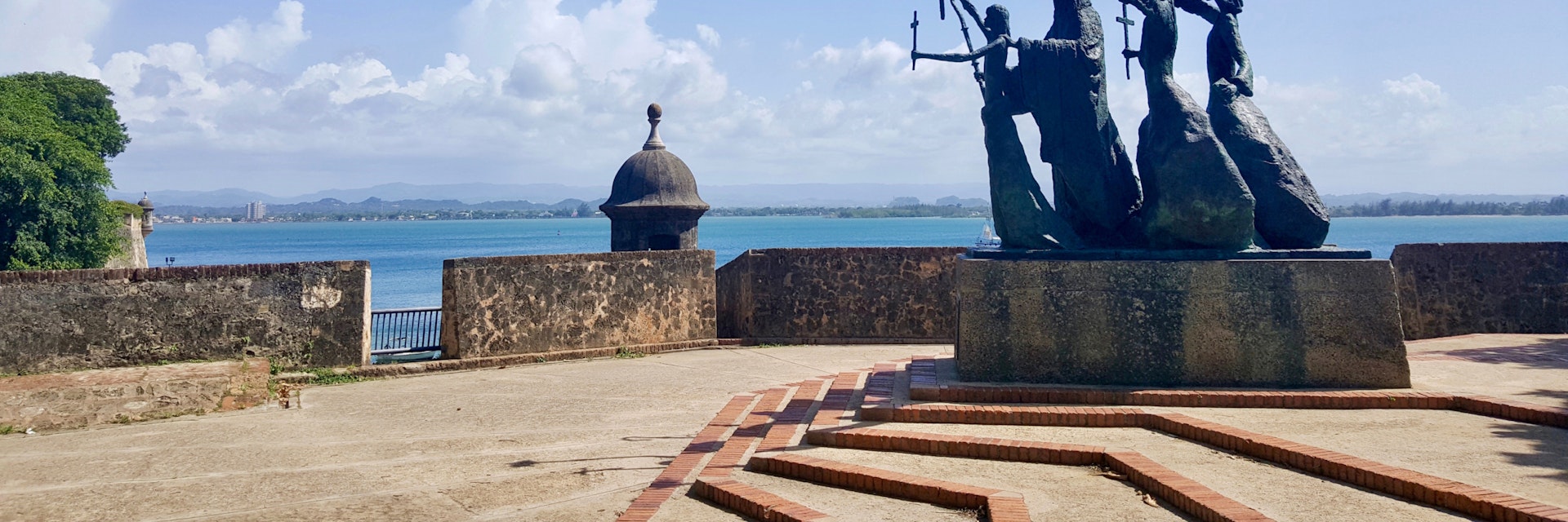 Side view of bronze statue by the water in Old San Juan.