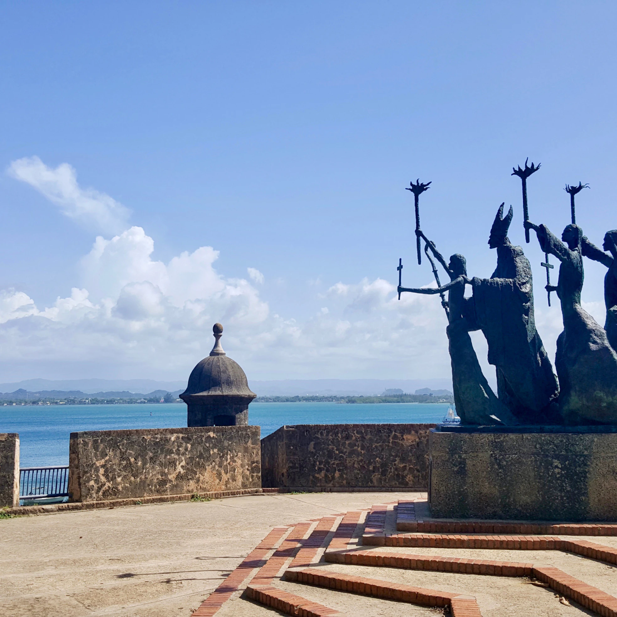 Side view of bronze statue by the water in Old San Juan.