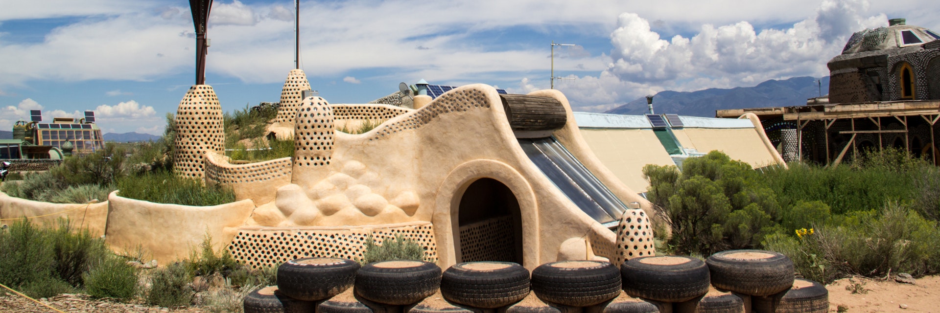 TAOS, NEW MEXICO-AUGUST 13: Building materials sit outside an earthship being built in Taos on August 13, 2014. Earthships are environmentally friendly homes made of recycled materials.; Shutterstock ID 210755425; Your name (First / Last): Alexander Howard; GL account no.: 65050; Netsuite department name: Online Editorial; Full Product or Project name including edition: Southwest POIs