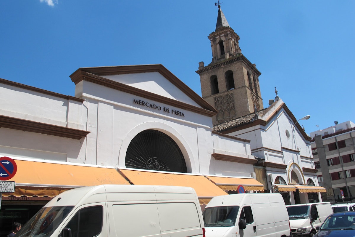 Market facade with vans and church, Mercado de Feria.