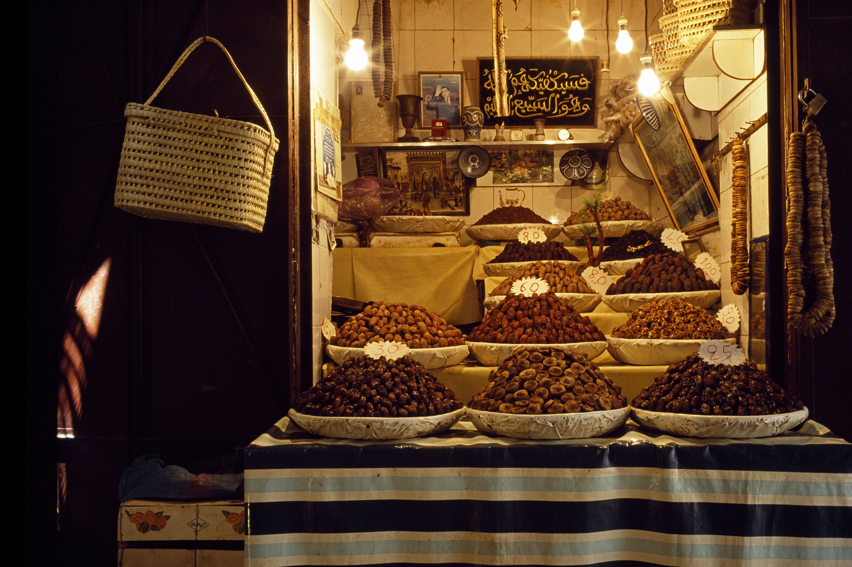 The date, fig and walnut stall next to the entrance of the Medersa El-Attarine deep in the ancient Medina of Fes, Morocco.