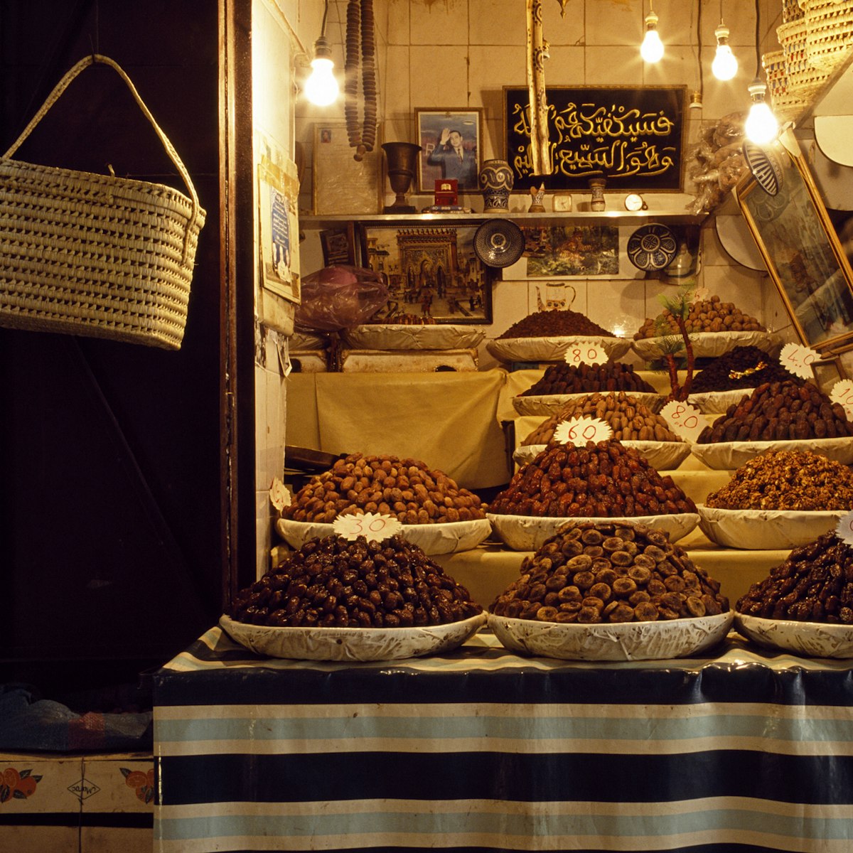 The date, fig and walnut stall next to the entrance of the Medersa El-Attarine deep in the ancient Medina of Fes, Morocco.