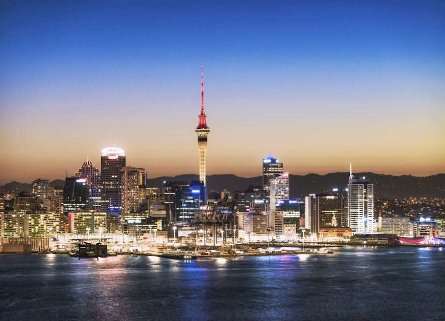 The Sky Tower in the centre of the buildings of Auckland's CBD, taken after sunset.