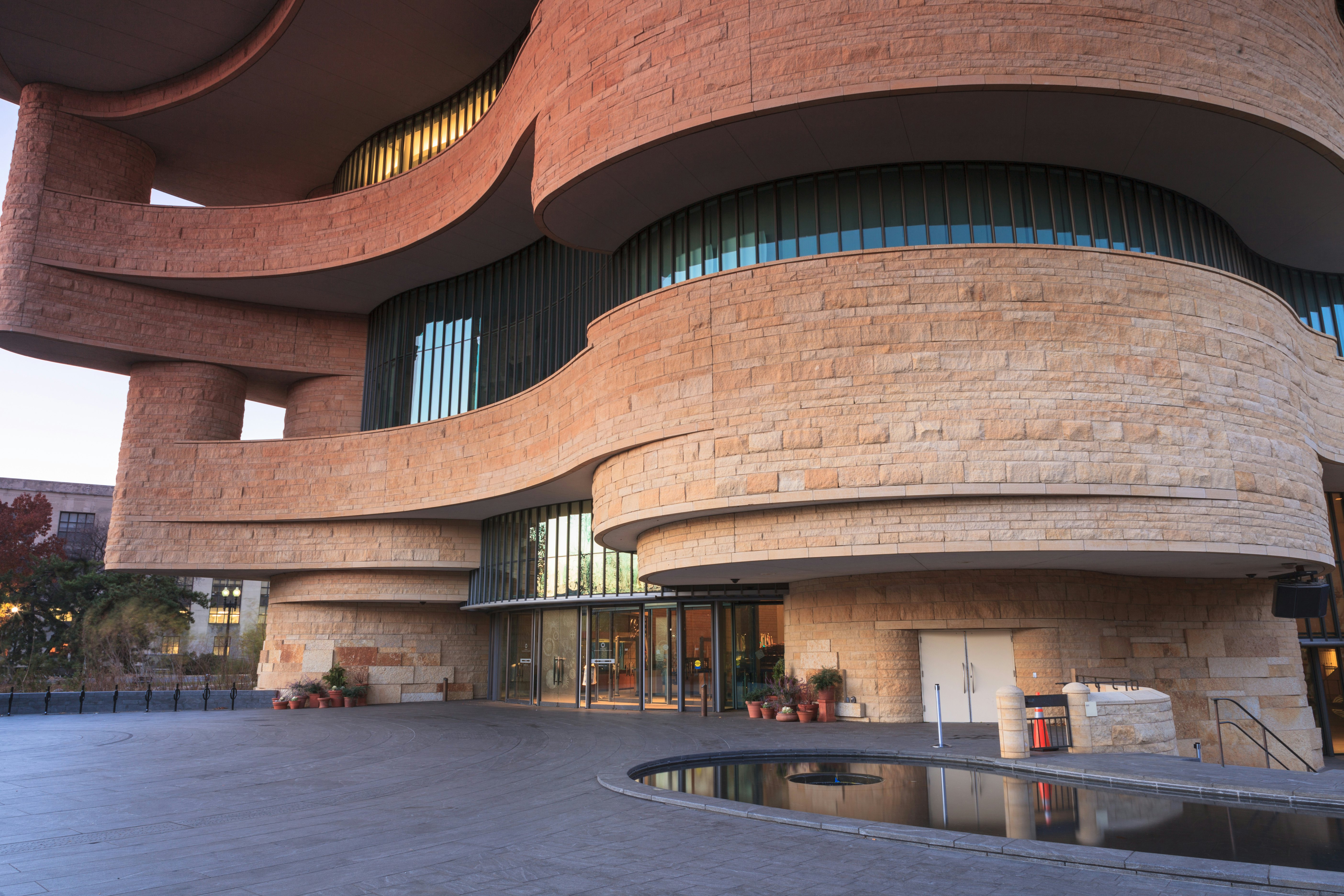 WASHINGTON, DC - NOVEMBER 30:  The entrance to the National Museum of the American Indian, as seen November 30, 2013, showcases the unusual curved architecture of the stone building.; Shutterstock ID 166031348; Your name (First / Last): Josh Vogel; Project no. or GL code: 56530; Network activity no. or Cost Centre: Online-Design; Product or Project: 65050/7529/Josh Vogel/LP.com Destination Galleries