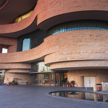 WASHINGTON, DC - NOVEMBER 30: The entrance to the National Museum of the American Indian, as seen November 30, 2013, showcases the unusual curved architecture of the stone building.; Shutterstock ID 166031348; Your name (First / Last): Josh Vogel; Project no. or GL code: 56530; Network activity no. or Cost Centre: Online-Design; Product or Project: 65050/7529/Josh Vogel/LP.com Destination Galleries