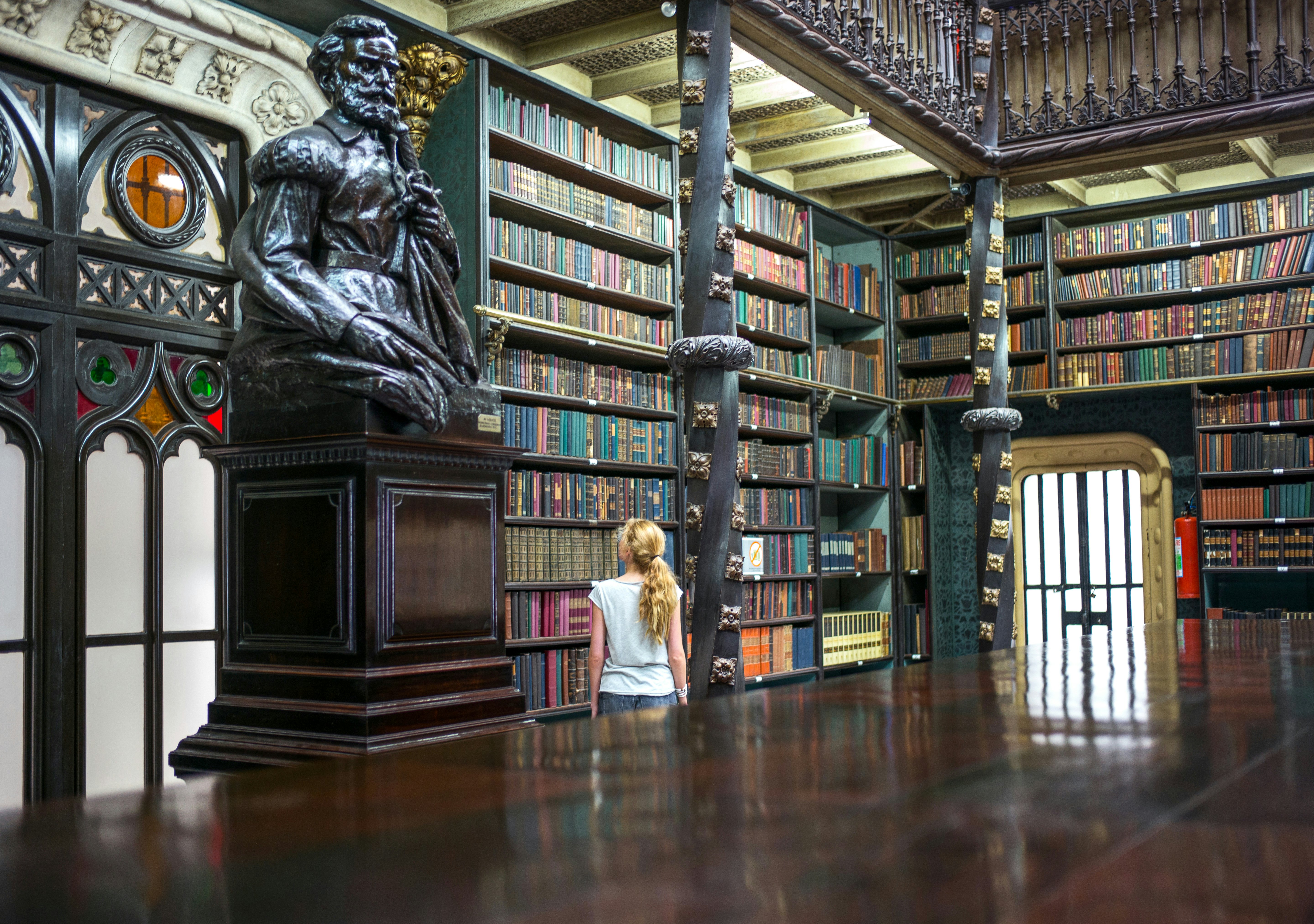 Rio De Janeiro, Brazil - September 5 2013: A girl looking at the books in the library Real Cabinete Portugues De Leitura, in the old city center; Shutterstock ID 267301388; Your name (First / Last): Josh Vogel; Project no. or GL code: 56530; Network activity no. or Cost Centre: Online-Design; Product or Project: 65050/7529/Josh Vogel/LP.com Destination Galleries