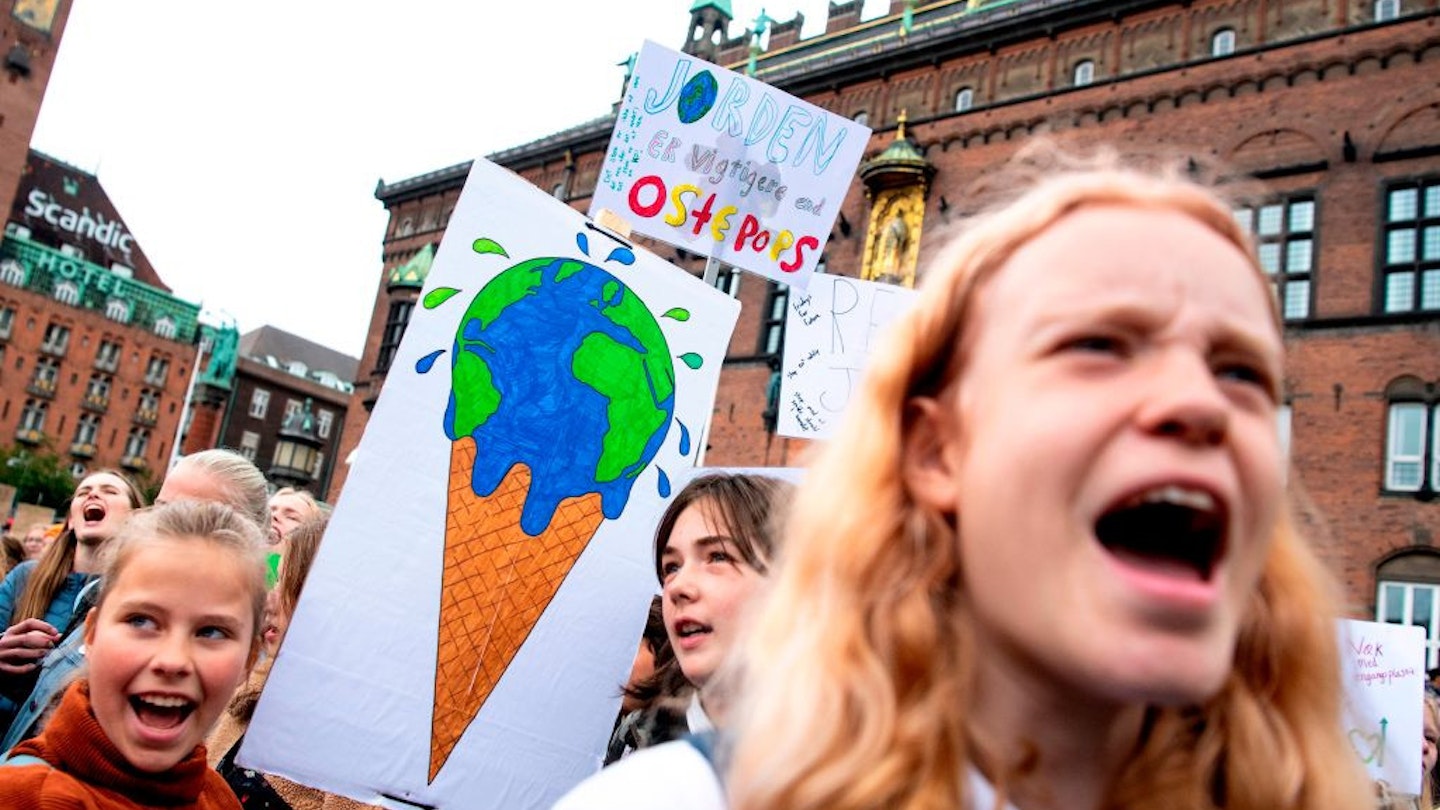 Young people hold signs in central Denmark. 